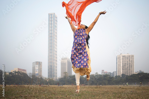 Indian woman making fun with red colored Churni at outdoors photo