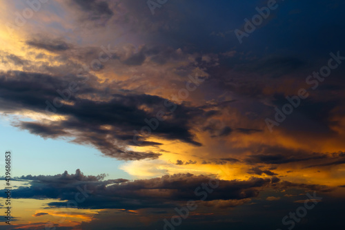 beautiful sunset sky, bright sunlight and silhouette of clouds as a background