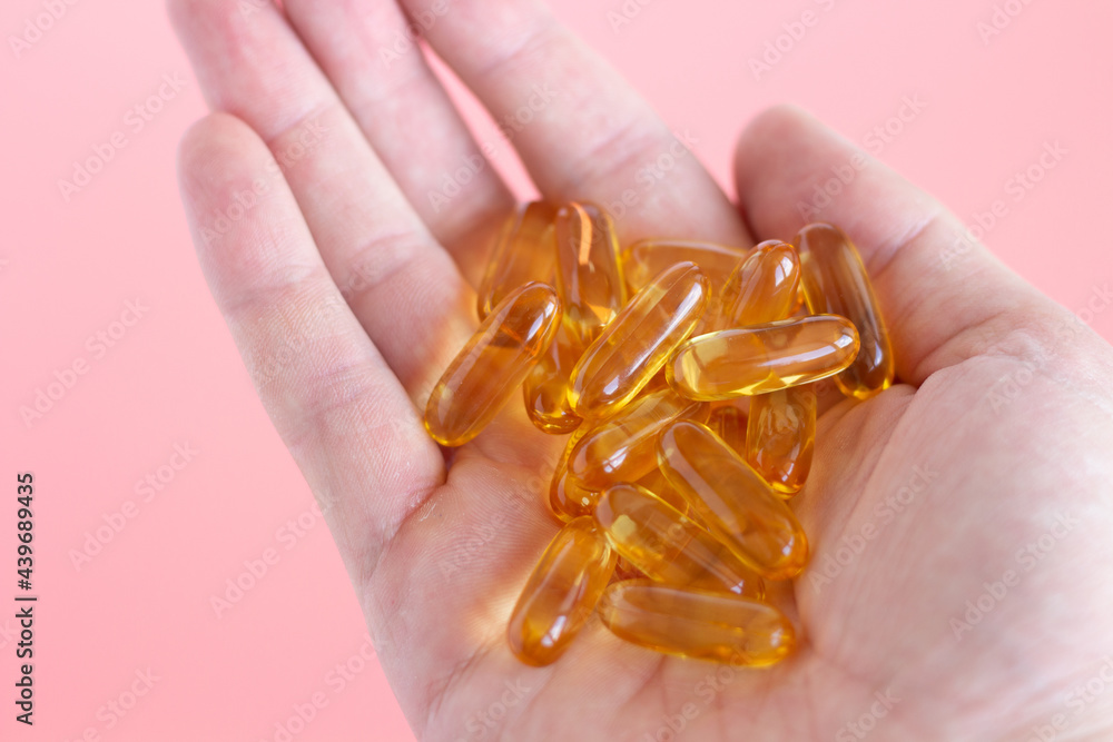 Hand holds omega-3. Handful of vitamins in hand Hand holds omega-3. Handful of vitamins in hand