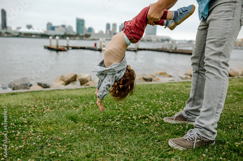 Dad dangling son upside down  photo