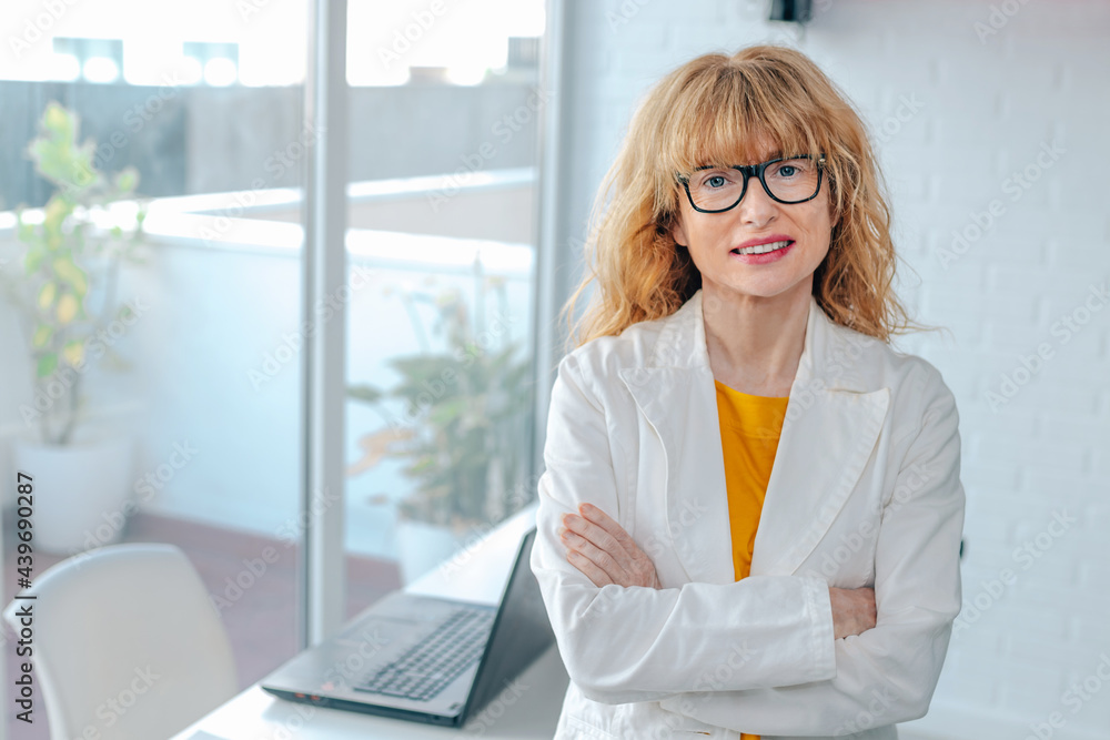 middle-aged blonde business woman in the office middle-aged blonde business woman in the office