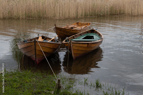 Three row boats bob in the water. © MariannePfeil