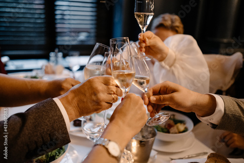 friends clink glasses of wine