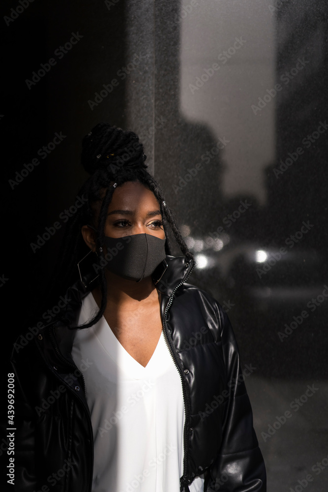 Black woman wearing a surgical mask Black woman wearing a surgical mask