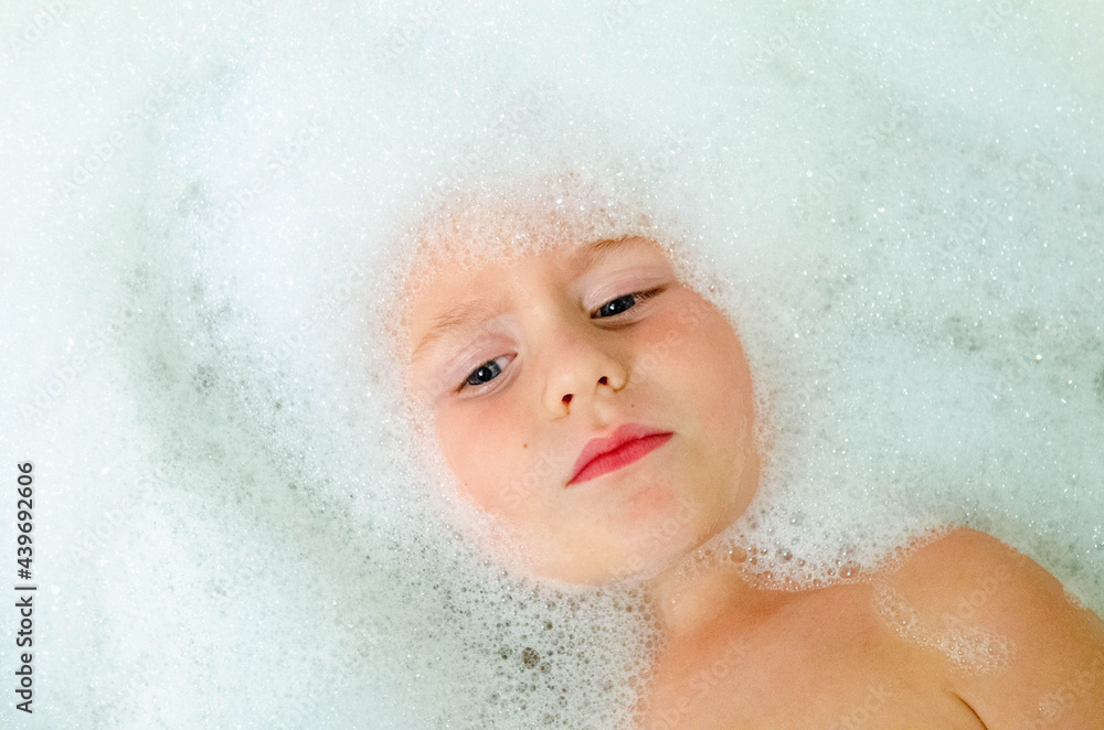 Young boy with bubbles in a bath Young boy with bubbles in a bath