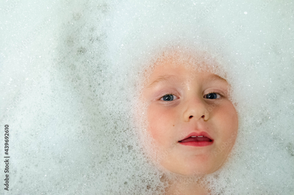 Young boy with bubbles in a bath Young boy with bubbles in a bath