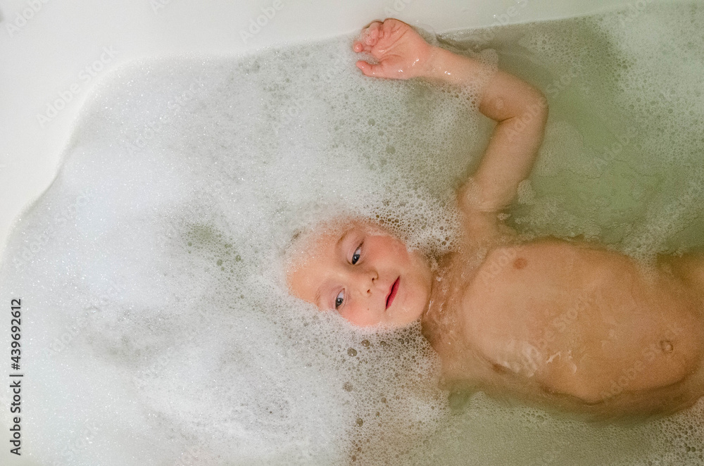Young boy with bubbles in a bath Young boy with bubbles in a bath