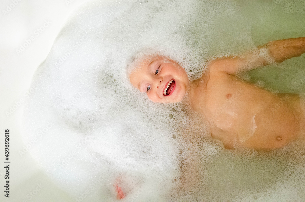 Young boy with bubbles in a bath Young boy with bubbles in a bath