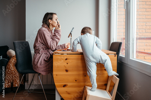 Mom doing makeup when baby interferes her.