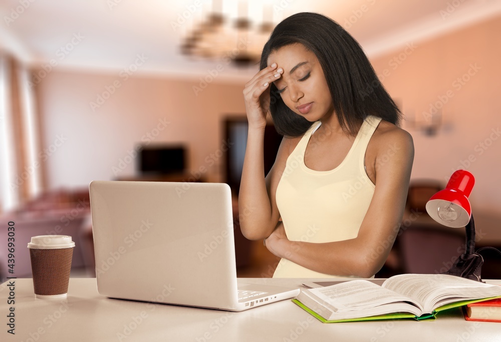 Stressed overworked business woman working from home from a laptop computer. Stressed overworked business woman working from home from a laptop computer.