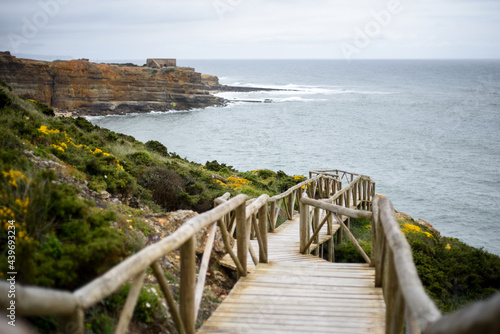 Wooden path on the cliff of Ericeira, Portugal photo