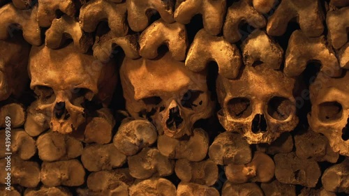 Paris Catacombs, human bones and skulls, closeup panning - Paris, France
