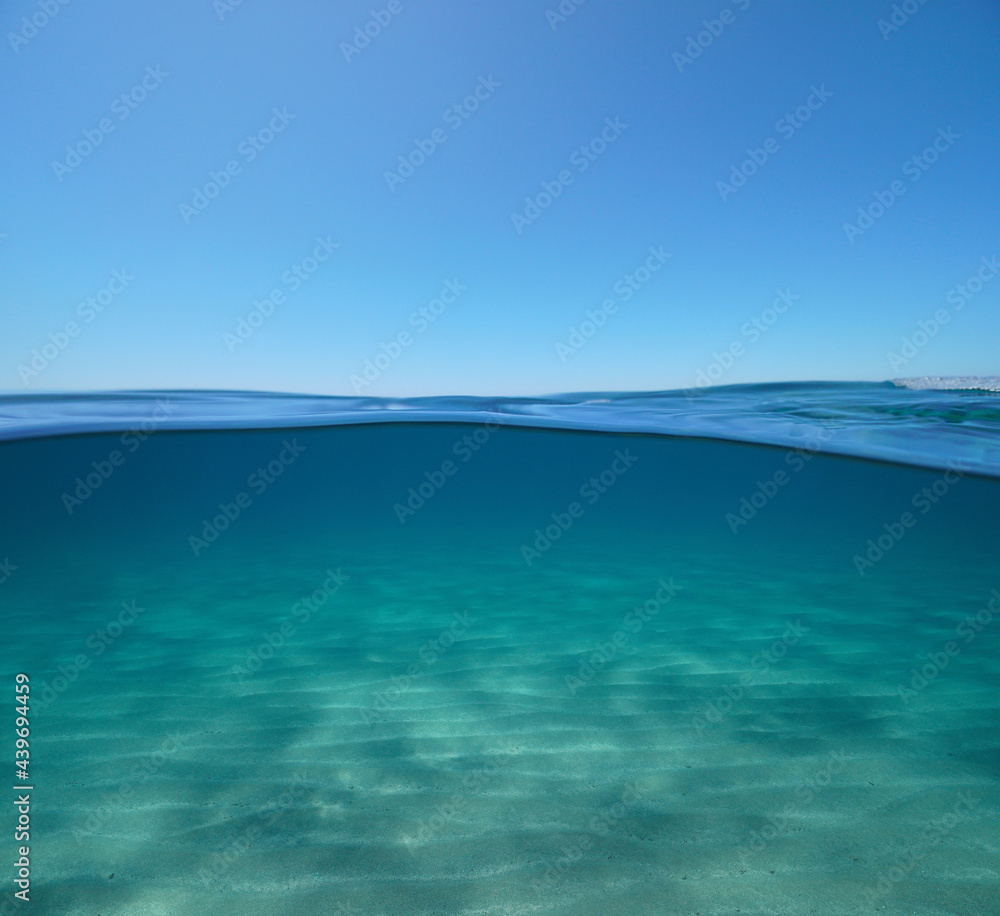 Blue sky with sand underwater sea, split view over and under water surface, Mediterranean sea