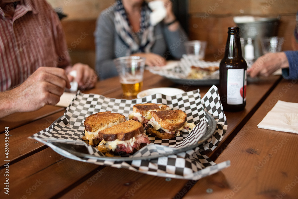 Closeup photo of a Reuben sandwich and beer. Closeup photo of a Reuben sandwich and beer.