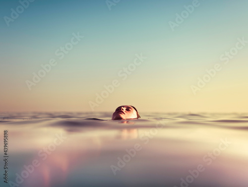 Female face floating in the water photo