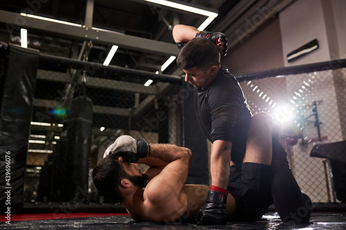 Two Professional MMA Fighters Boxing In Action. Muscular Athletes. Sport, Healthy Lifestyle, Competition, Dynamic And Motion, Action Concept. Copyspace. Side View