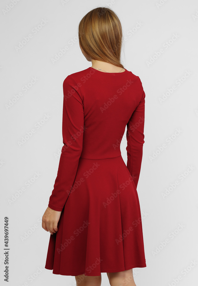 Gorgeous woman. Portrait of beautiful smiling young woman standing in cute red dress isolated on white background in full length. the concept of advertising dresses for the store Gorgeous woman. Portrait of beautiful smiling young woman standing in cute red dress isolated on white background in full length. the concept of advertising dresses for the store