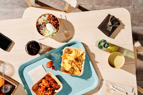 Various delicious Mexican fast food on wooden table