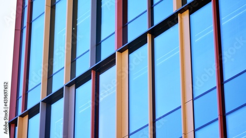 Glass facade of the buildings with a blue sky. Modern building in the business city center. Background of modern glass buildings. 