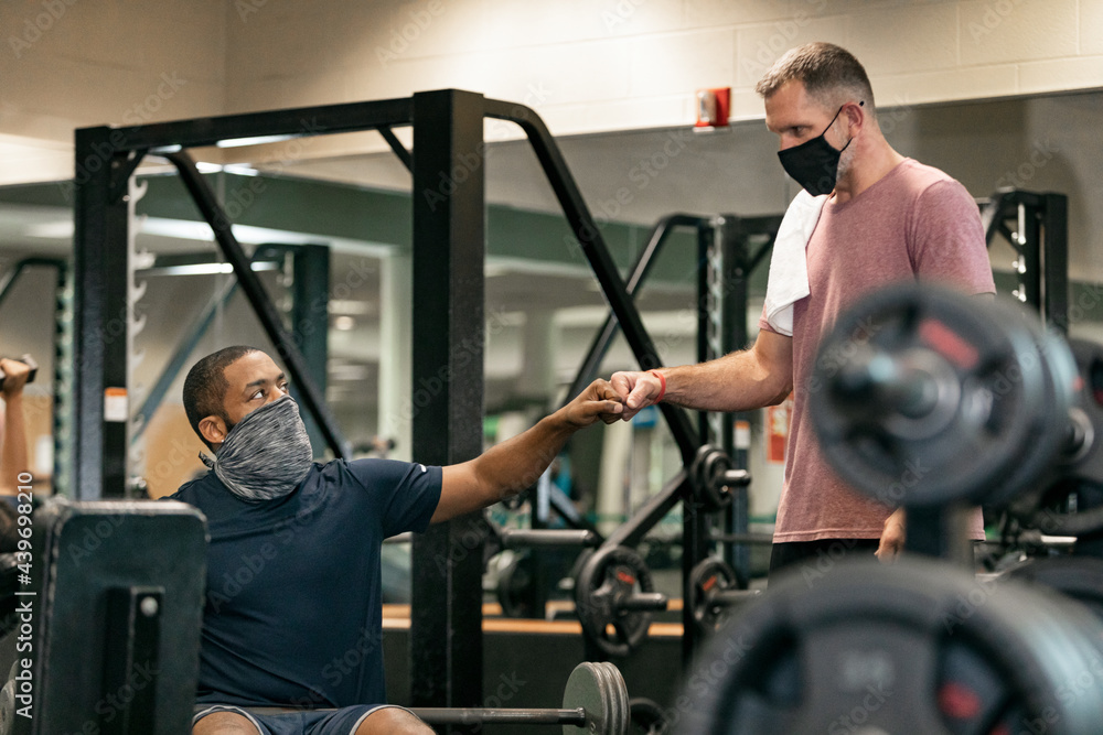 Gym: Friends Fist Bump During Workout Gym: Friends Fist Bump During Workout