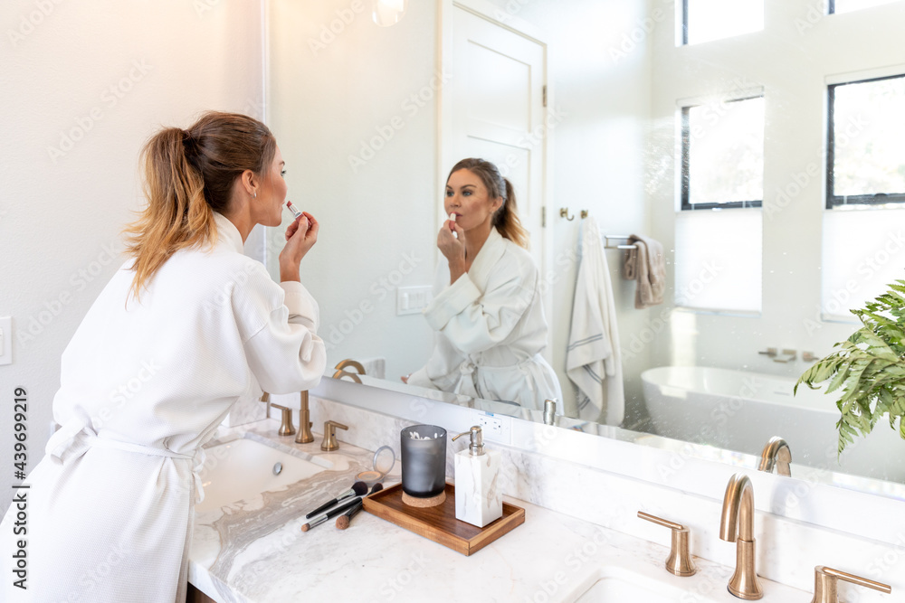 Woman in a Luxury Hotel Room Gets Ready in the Mirror Woman in a Luxury Hotel Room Gets Ready in the Mirror