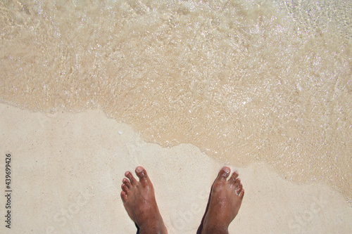 Feet in the sand at the seaside