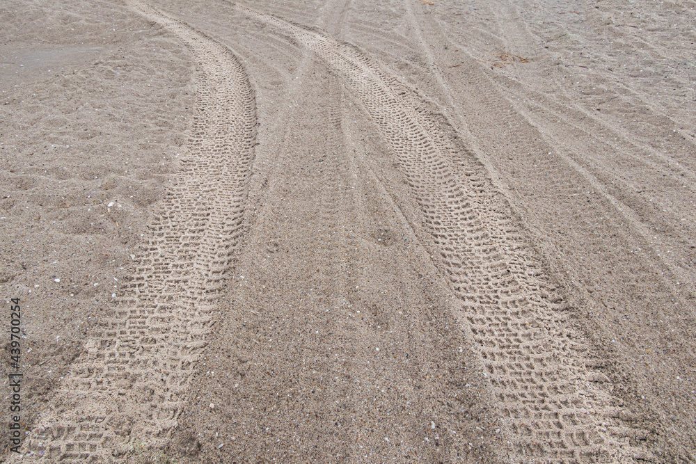 off road car Tyre track on sandy beach, with ocean and blue sky off road car Tyre track on sandy beach, with ocean and blue sky