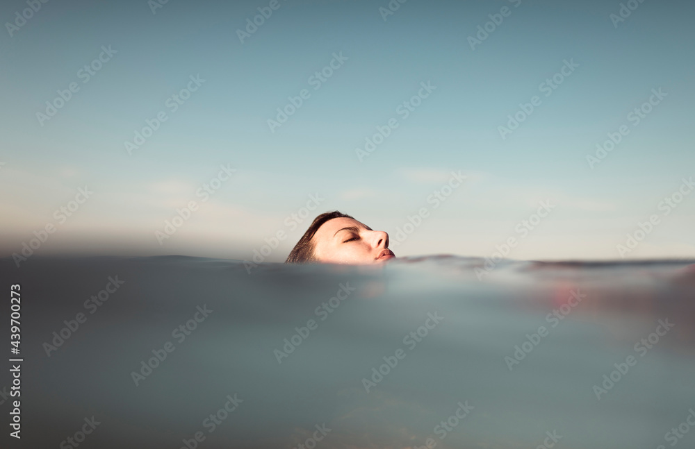 © Ibai Acevedo/Stocksy - Girl head on the sea surface