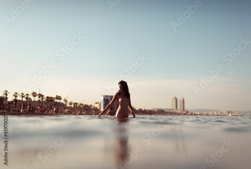 Girl entering into the waters of Barcelona beach photo