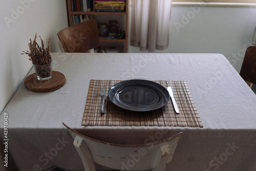 Dining table furnished with cutlery for one person
 photo