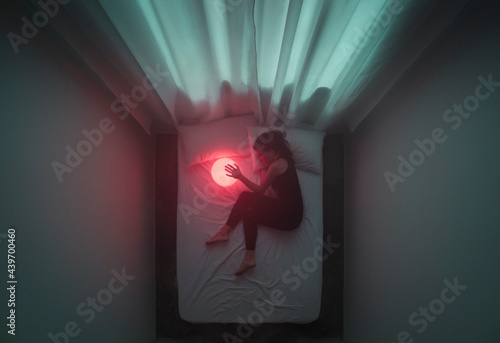 Woman touching a red lamp photo