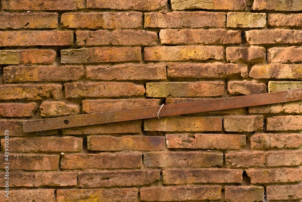old brick wall texture with a rusty piece of iron running through it old brick wall texture with a rusty piece of iron running through it