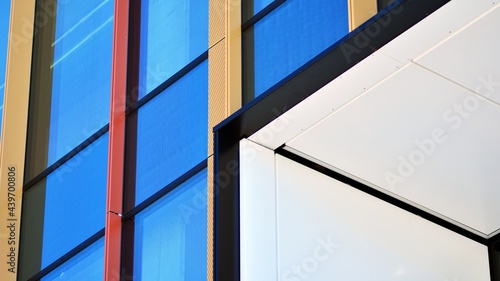 Glass facade of the buildings with a blue sky. Modern building in the business city center. Background of modern glass buildings. 