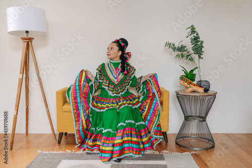 Portrait girl dressed up with a traditional Mexican dress and braid hairstyle photo
