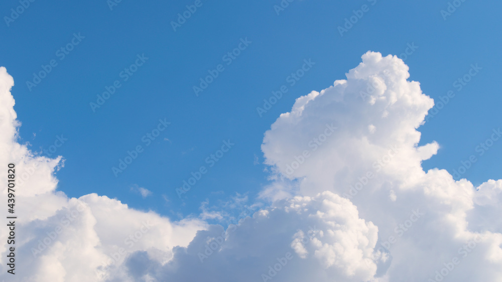 Fluffy white clouds on a blue sky