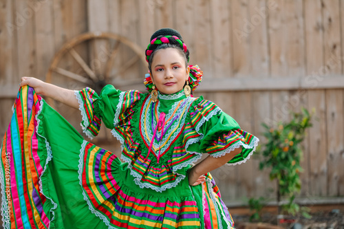 Portrait of a Mexican-American girl dressed up with a Mexican dress photo