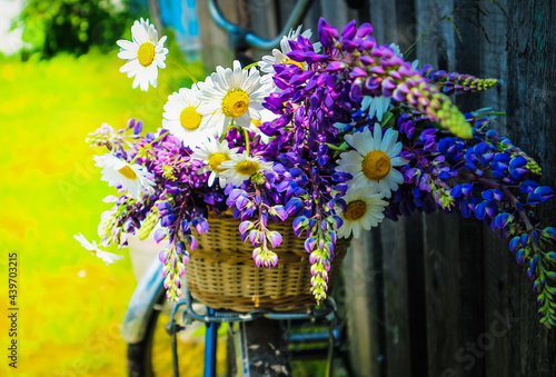 bouquet of wild flowers in a basket and on a bicycle
