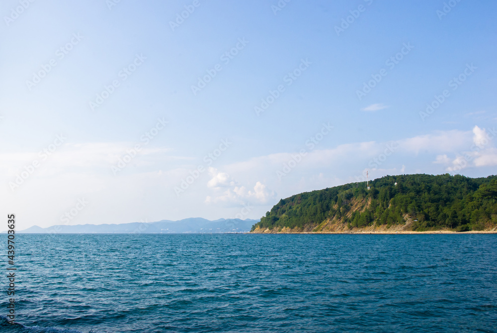 sea landscape is a pebbly beach with waves in white foam