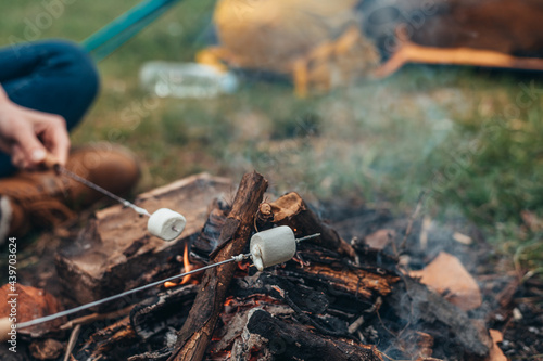 Marshmallows on a stick above the camping fire