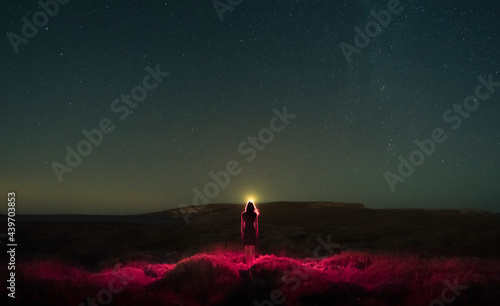 Female red silhouette under the night sky