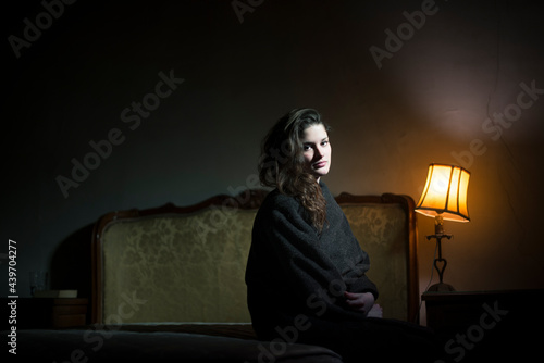 Dark portrait of a woman looking at camera