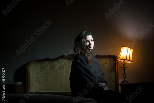 Dark portrait of a woman looking at camera photo