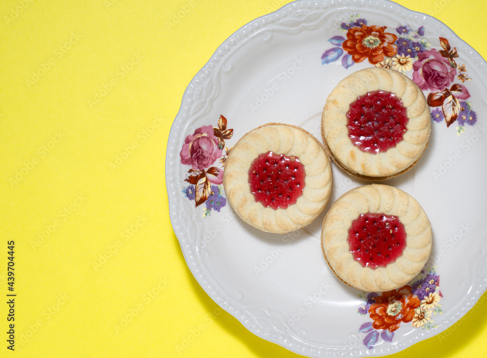 3 sweet raspberry cookies on decorated plate 3 sweet raspberry cookies on decorated plate