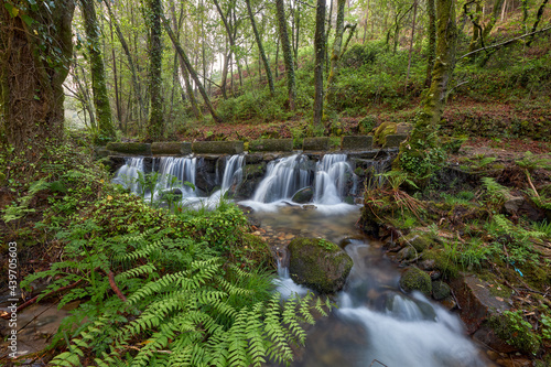 Small waterfalls formed by the river Tripes in the natural park of Mount Aloia Park, in the area of Galicia, Spain. photo