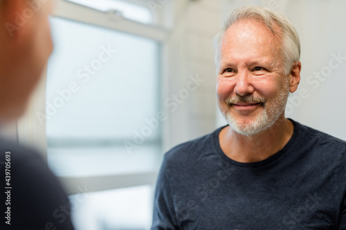 Middle-aged Man Lovingly Looks at Himself in the Mirror photo