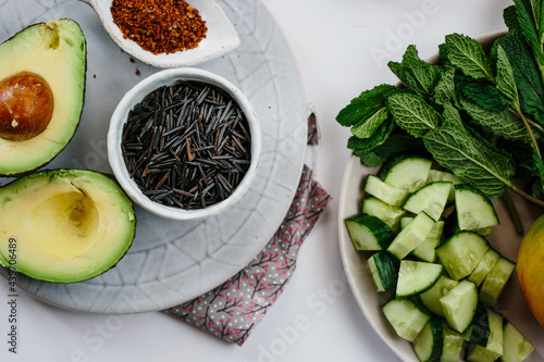 Fresh crab meat, rice, avocado, mango  and seasoning for a salad. photo