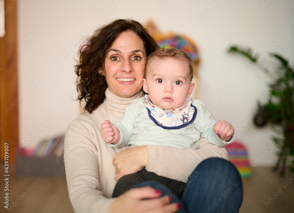 Content woman with baby at home Content woman with baby at home