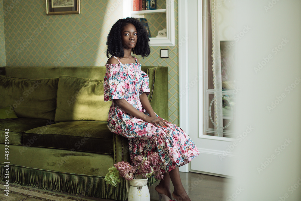 girl in a dress on a green sofa girl in a dress on a green sofa