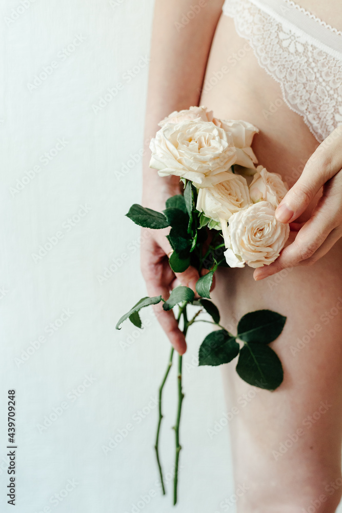 Anonymous woman in lingerie with white roses Anonymous woman in lingerie with white roses