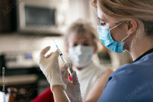 Health: Nurse Flicks Syringe To Remove Air photo